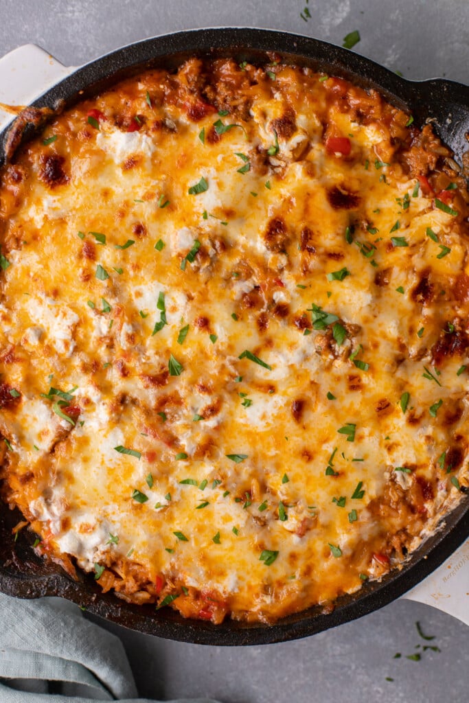A close up overhead shot of unstuffed peppers skillet on a grey background