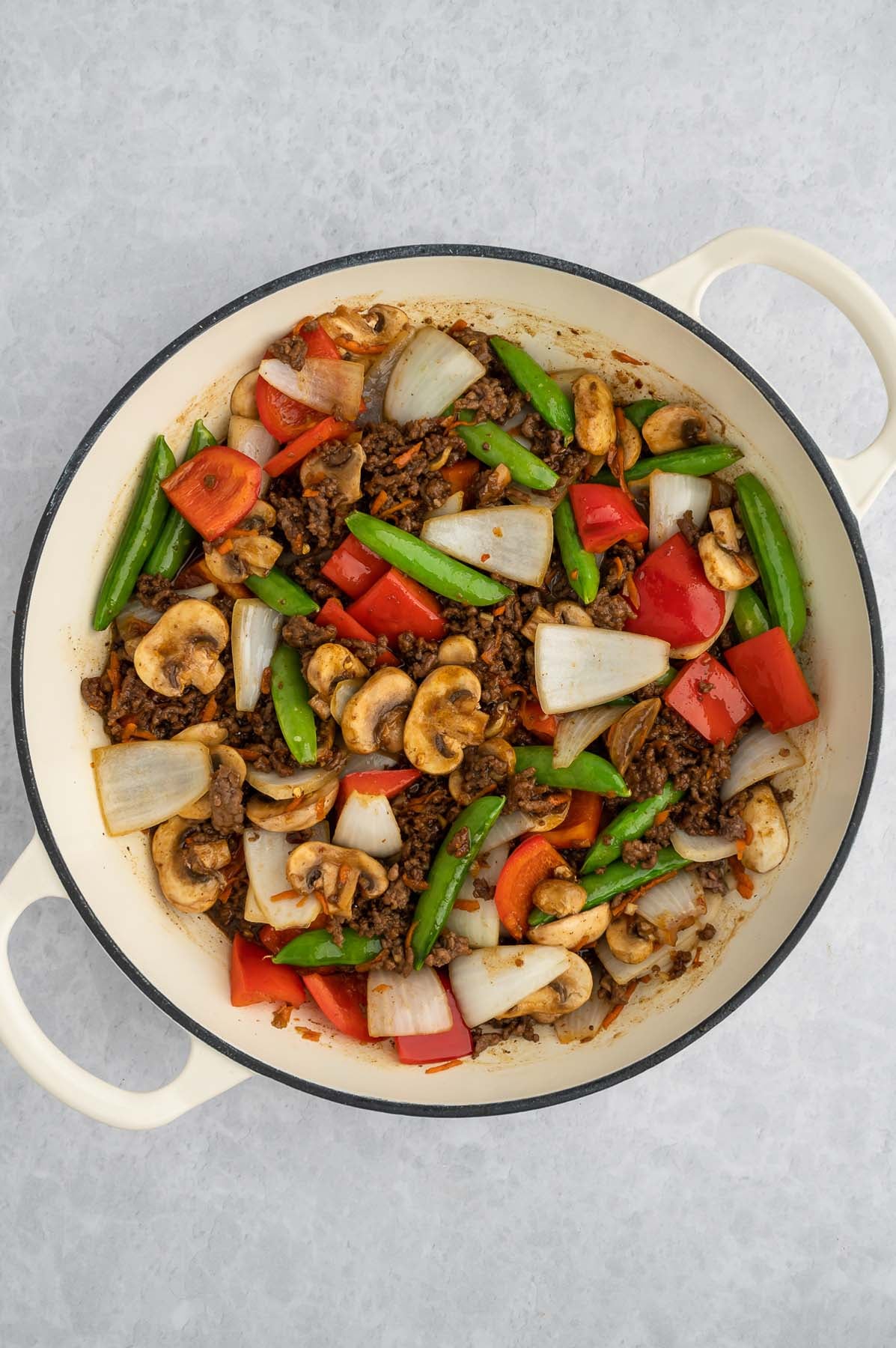 Healthy beef stir fry in a dutch oven, viewed from overhead.