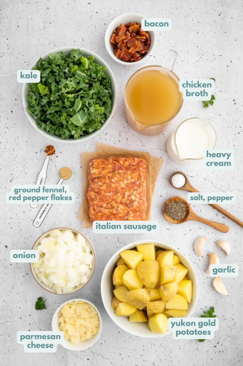 Ingredients for healthy zuppa toscana soup in small bowls: Italian sausage, onion, garlic, yukon gold potatoes, pepper, salt, fennel seed, red pepper flakes, chicken broth, heavy cream or coconut cream, kale, olive oil, bacon, parmesan cheese