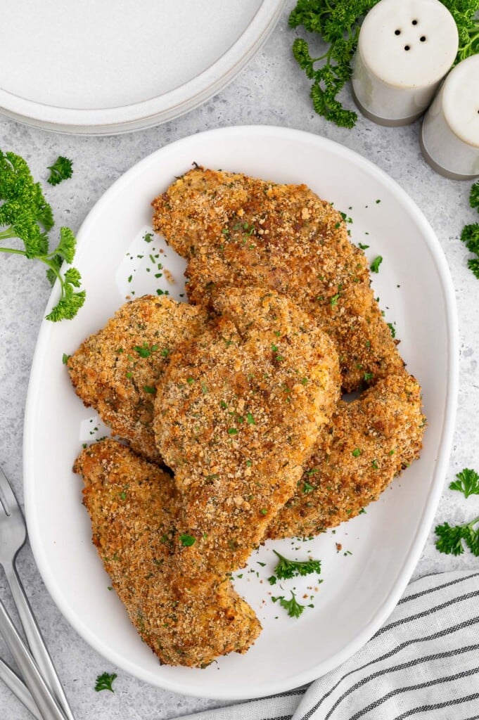 Baked Chicken Cutlets on a white platter.