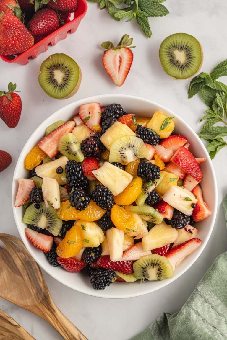 A large white bowl filled with a fruit salad.