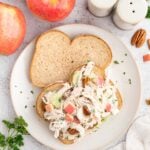 Greek Yogurt Chicken Salad on an open faced sandwich on a grey background