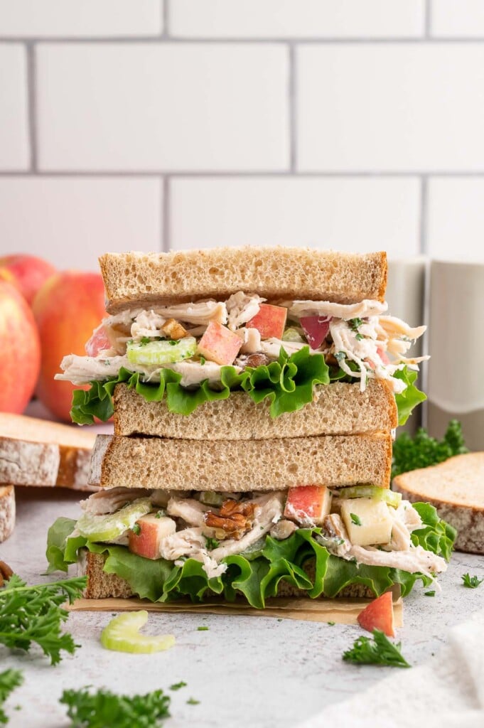 Greek yogurt chicken salad on a halved sandwich stacked on top of each other. 
