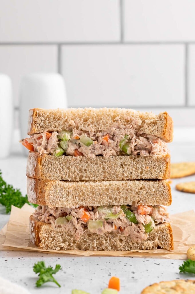 A halved Healthy Tuna Salad sandwich stacked on top of each other.