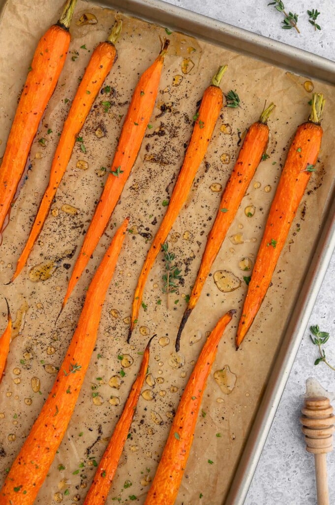 Honey Roasted Carrots on a parchment lined baking sheet.