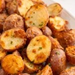 Garlic Roasted Potatoes on a white platter.