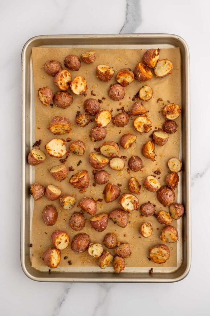 Garlic Roasted Potatoes on a parchment lined baking sheet.