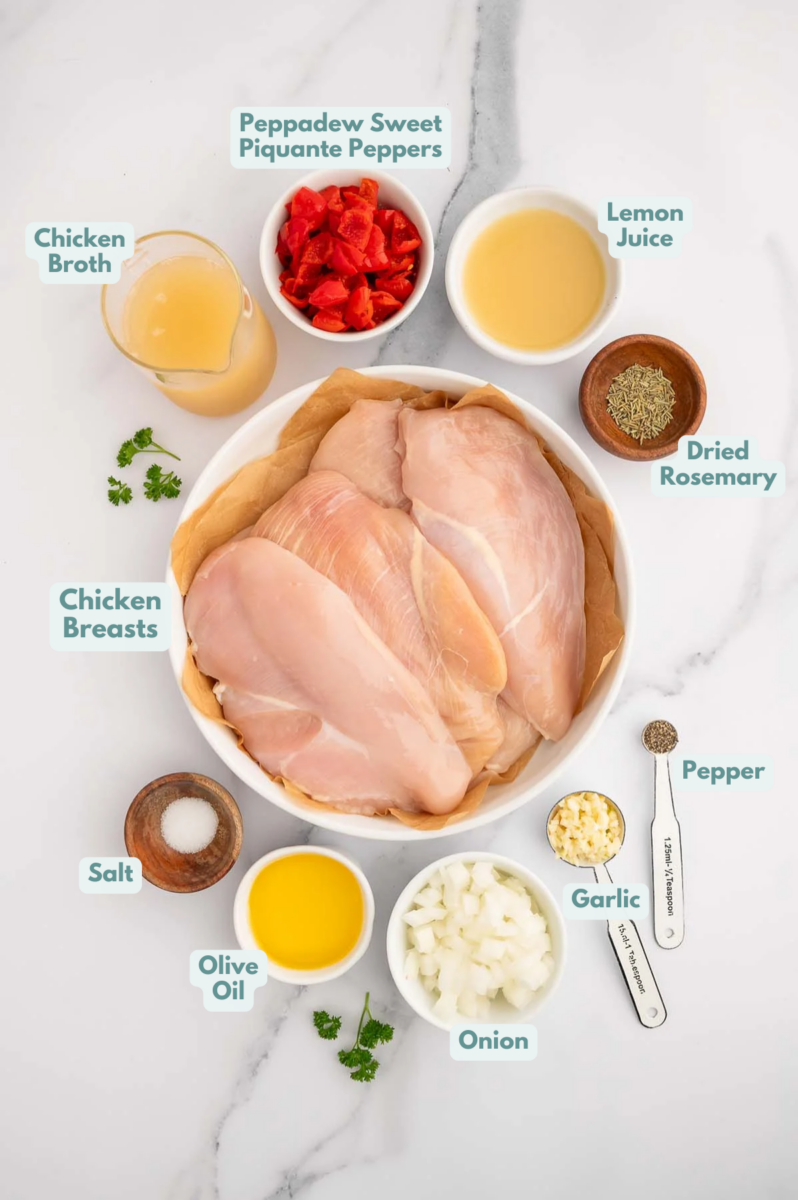 Ingredients for Chicken Scarpariello in small bowls: olive oil, chicken breasts, salt, pepper, garlic, onion, peppadew piquante peppers, chicken broth, dried rosemary, lemon juice