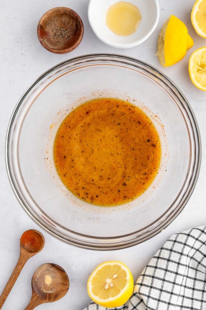 Vinegar coleslaw dressing in a clear large bowl. 