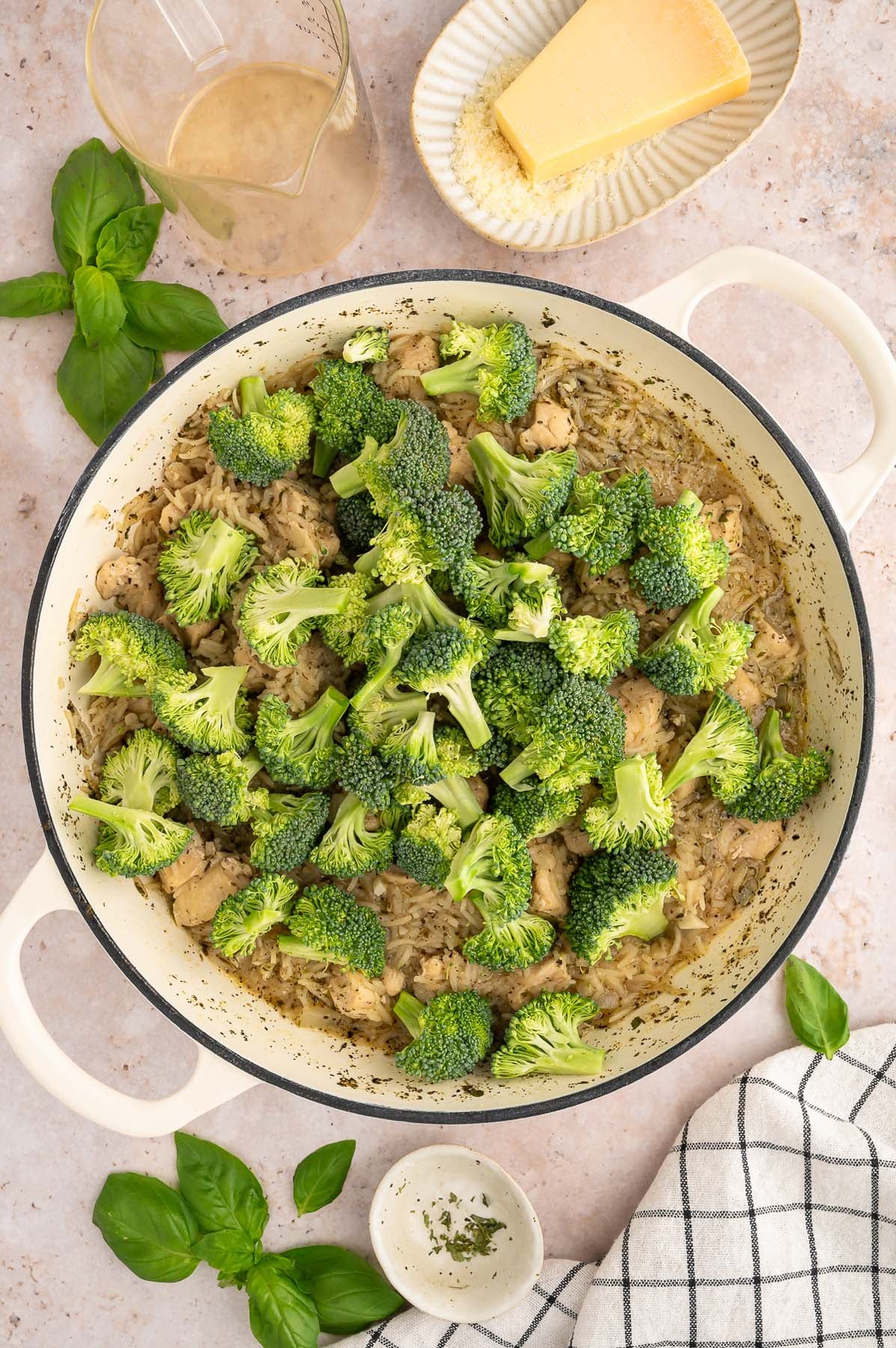 Uncooked broccoli florets in a large pot, viewed from overhead.