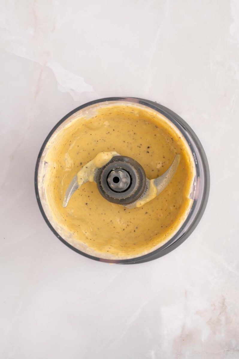 Caesar salad dressing blended in a small food processor. 