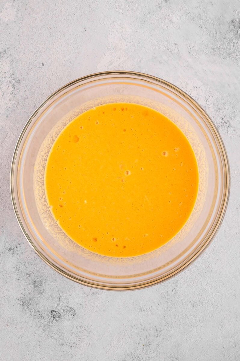 Wet ingredients for pumpkin protein muffins in a clear bowl. 