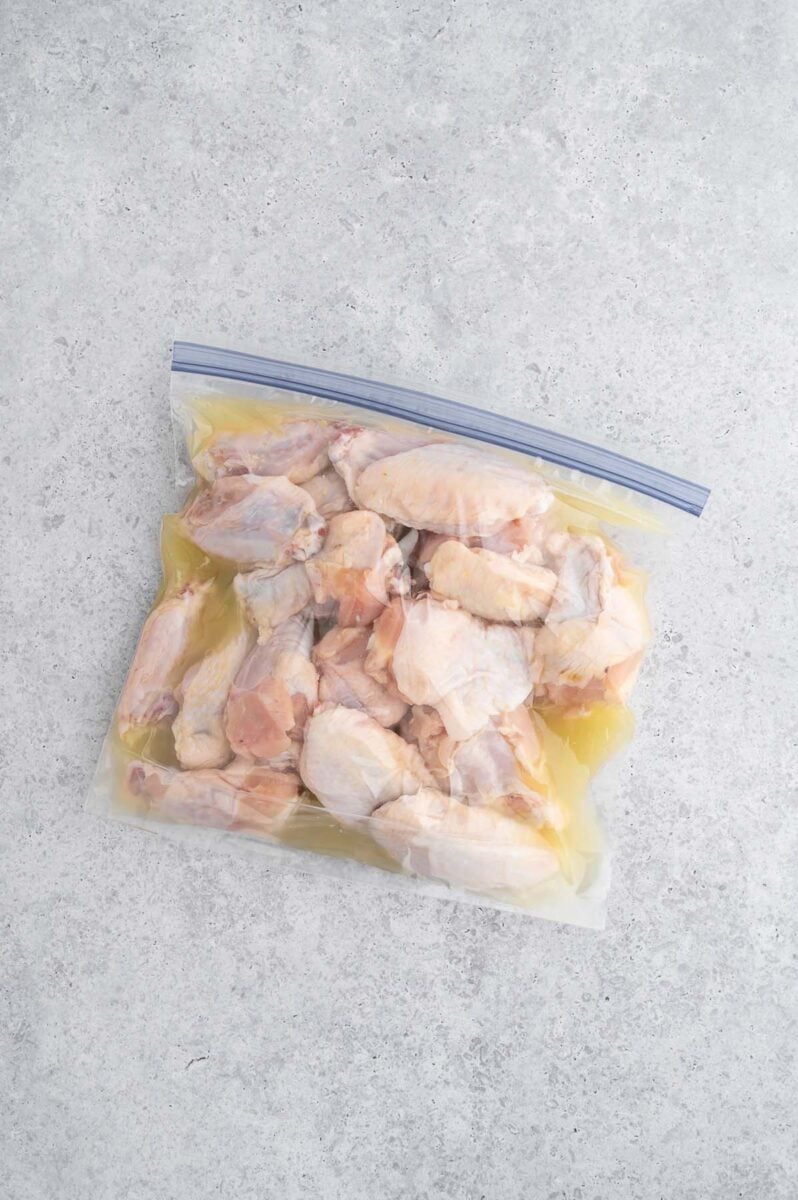 Chicken wings marinating in pickle juice in a ziploc bag.