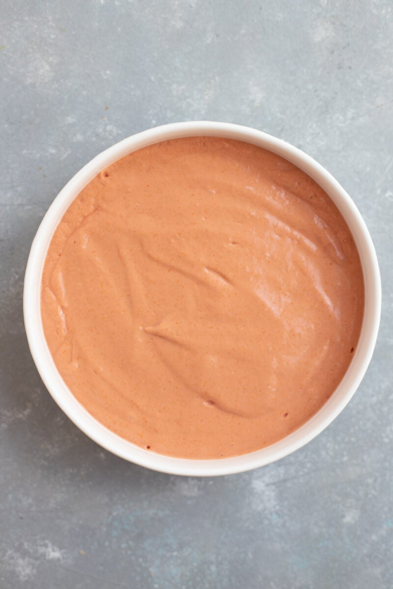 Vodka pasta sauce in a white bowl on a grey background.