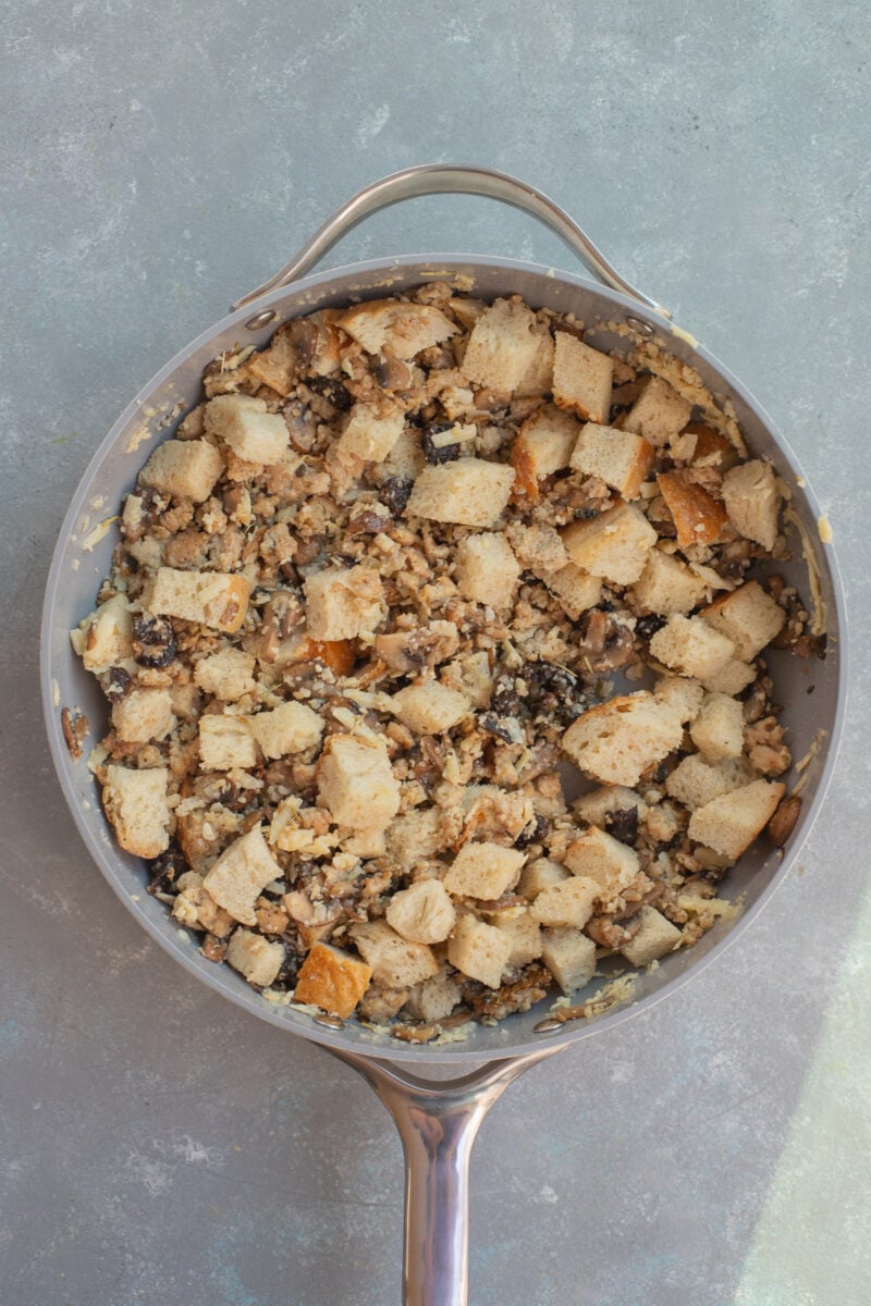 Ingredients for sourdough sausage stuffing in a pan after stirring together before baking.