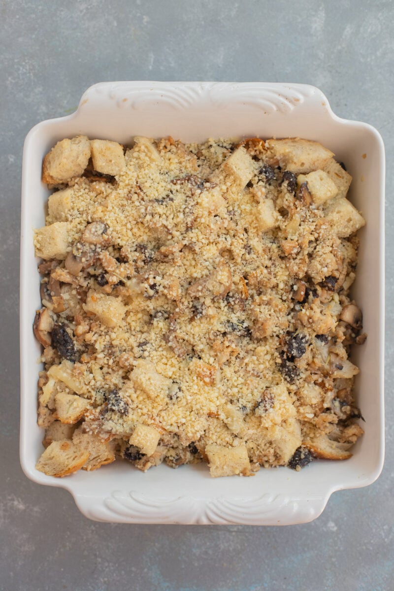 Uncooked Sourdough sausage stuffing in a white baking dish.