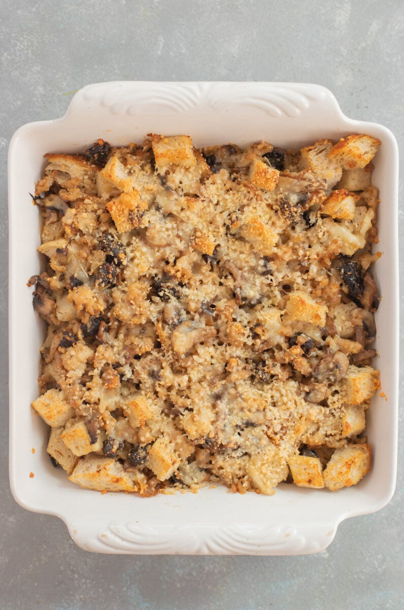 Sourdough sausage stuffing in a white baking dish right out of the oven.