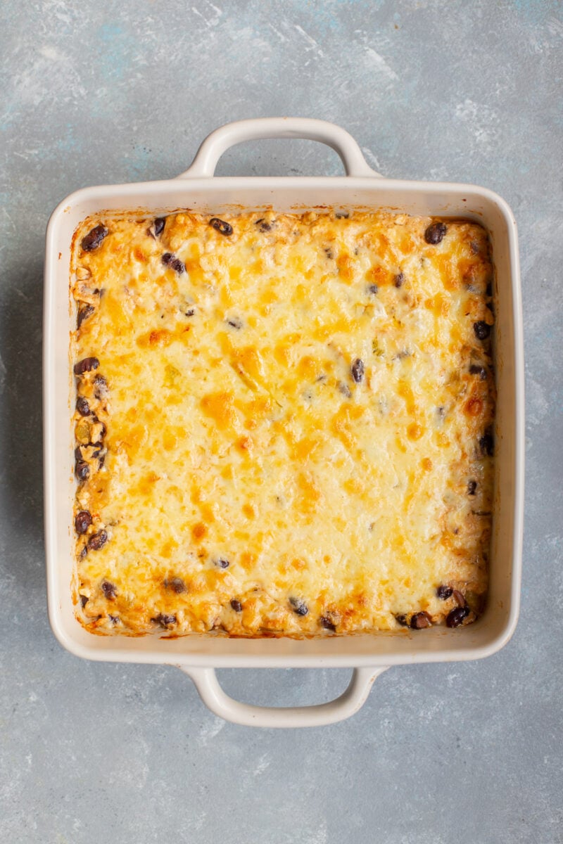 Chicken enchilada dip in a baking dish fresh out of the oven.
