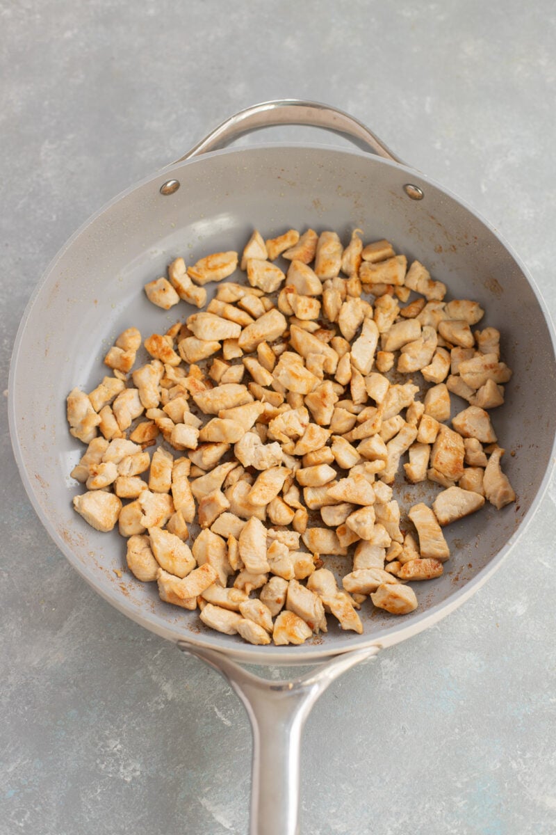 Browned chicken pieces in a large skillet.