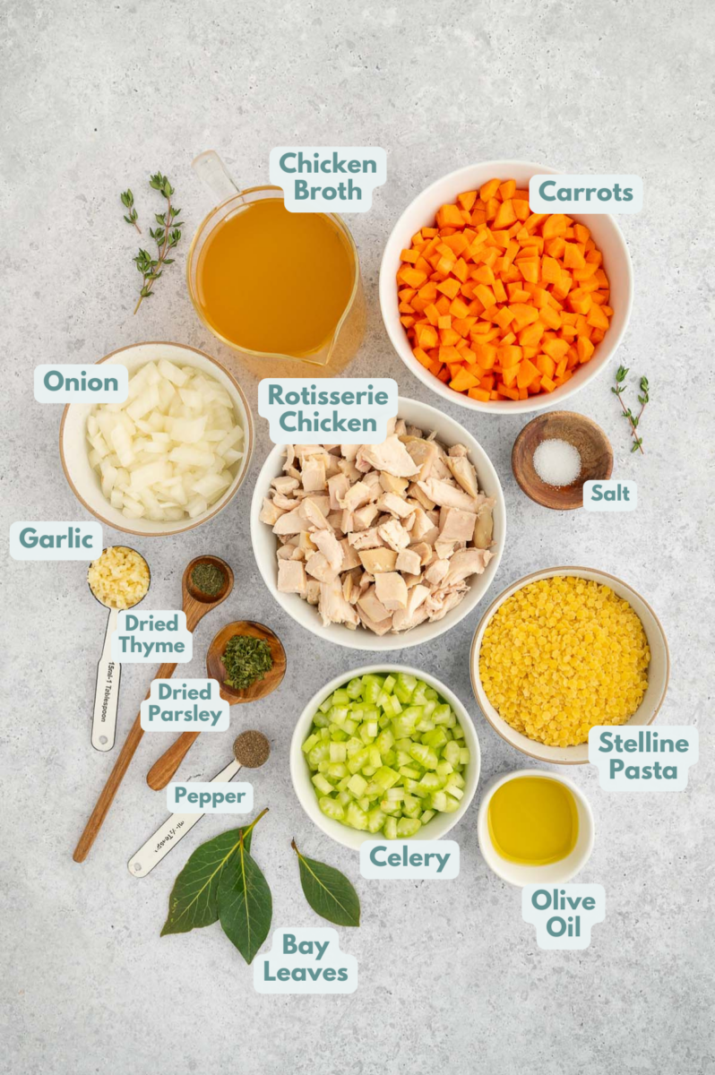 Ingredients for chicken stars soup in bowls on a counter. 