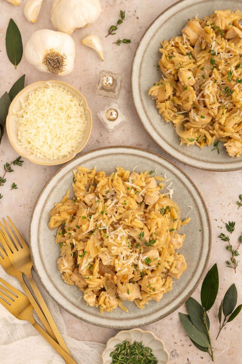 French Onion Orzo on a plate and another plate on the side with more ingredients on the side.