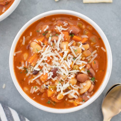 a large bowl of 15 bean soup with spoons and saltines on the side