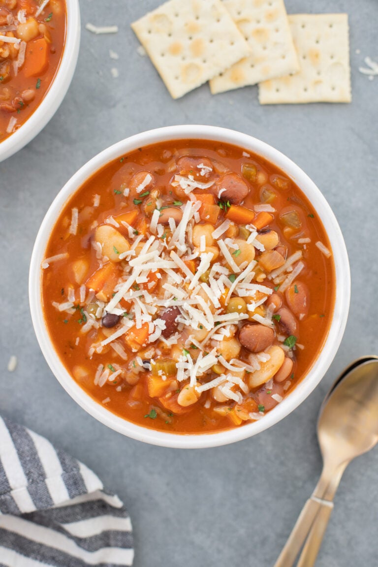 a large bowl of 15 bean soup with spoons and saltines on the side