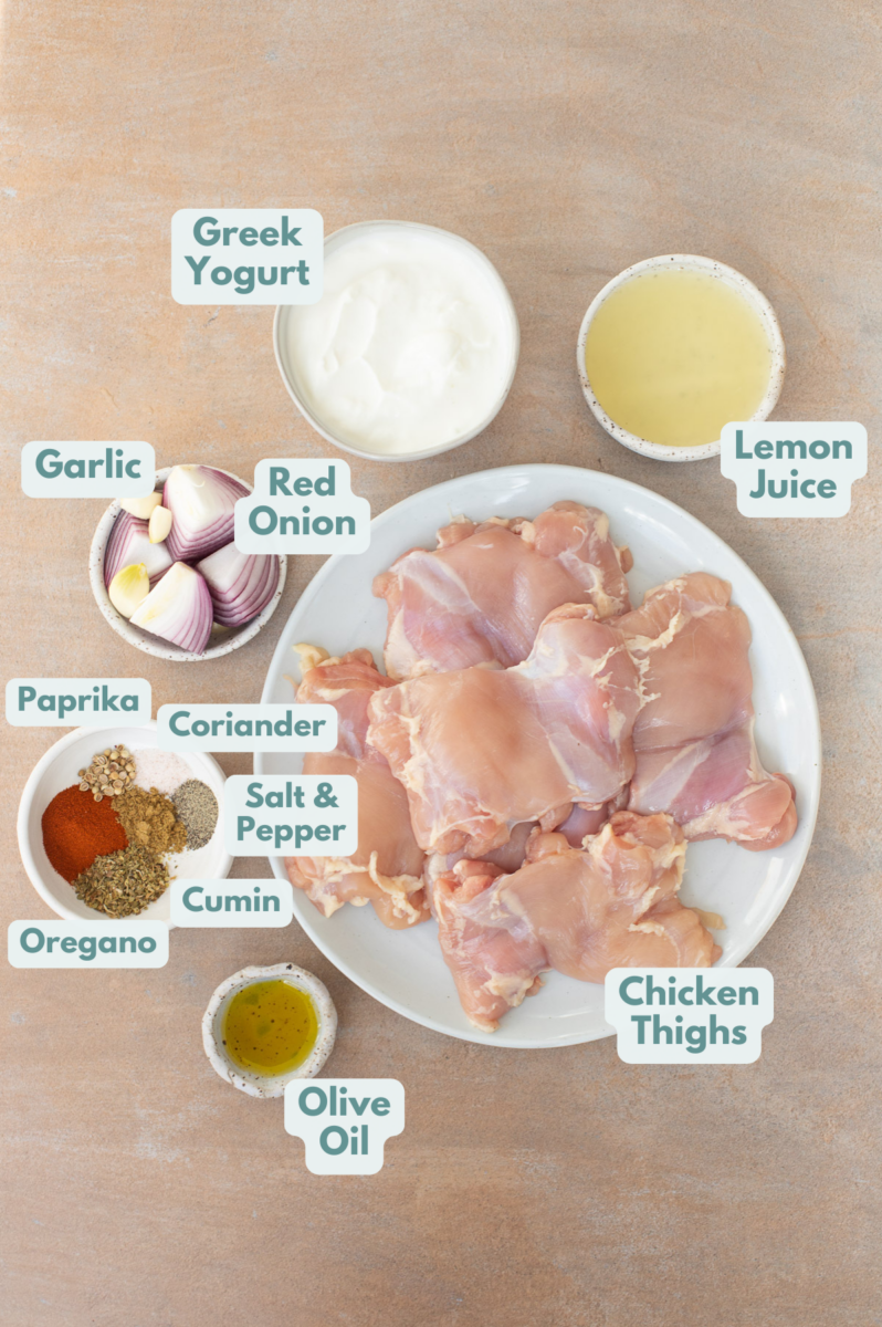 Labeled ingredients for grilled greek yogurt chicken thighs in small bowls.