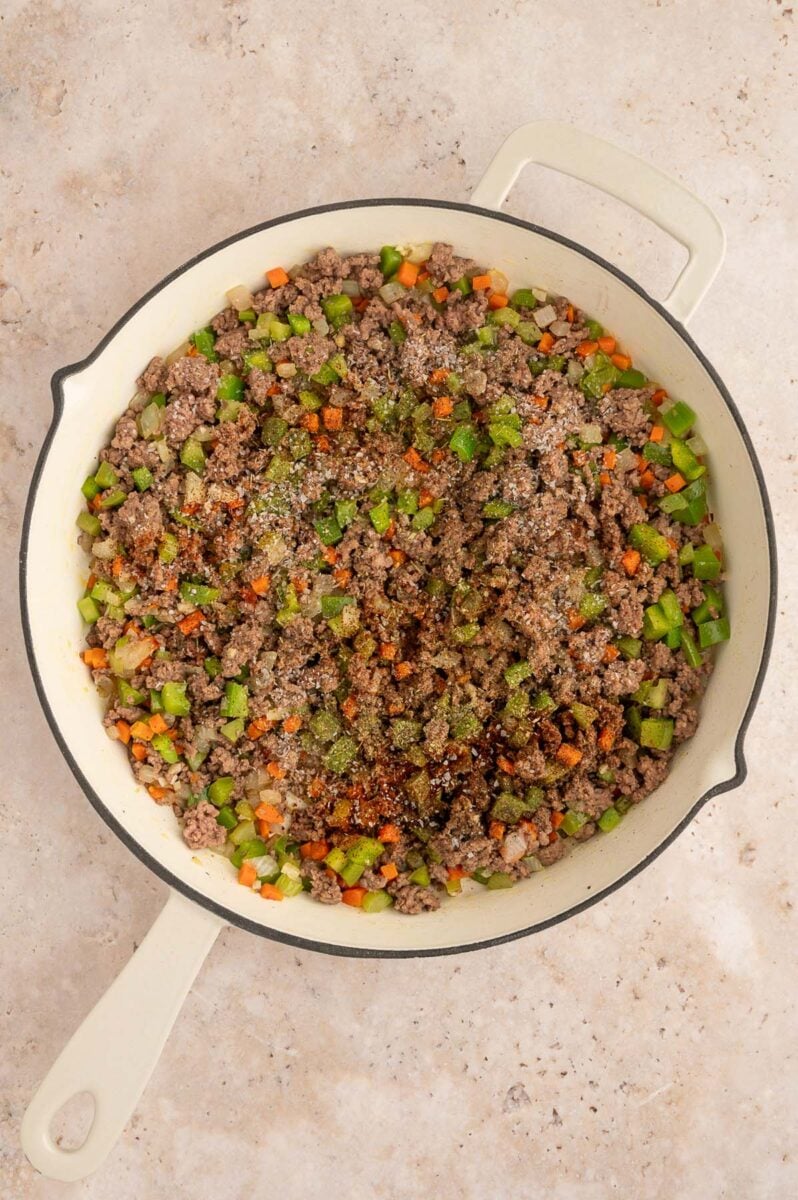 Chopped veggies and ground meat in a skillet.