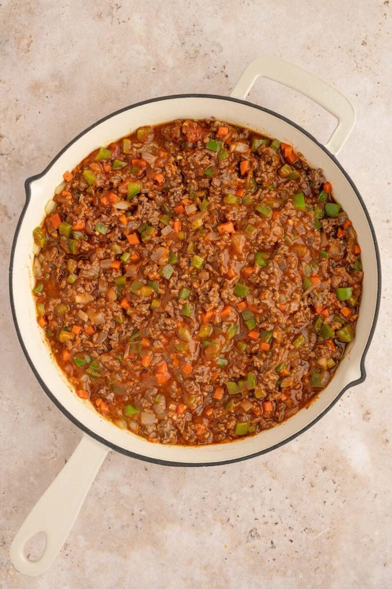 Ingredients for healthy sloppy joe mixture in a skillet before fully cooking.
