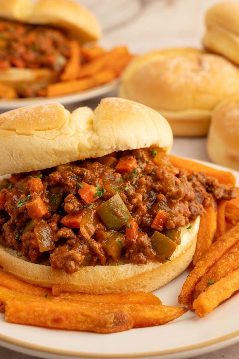 Healthy sloppy joe sandwich with sweet potato fries on the plate.