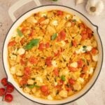 An overhead shot of chicken caprese orzo in a pan.