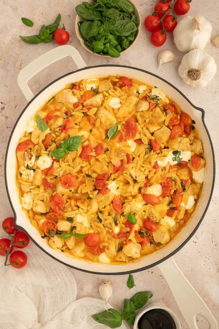 An overhead shot of chicken caprese orzo in a pan.