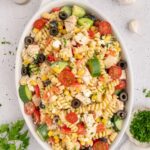 A white dish filled with high protein pasta salad.