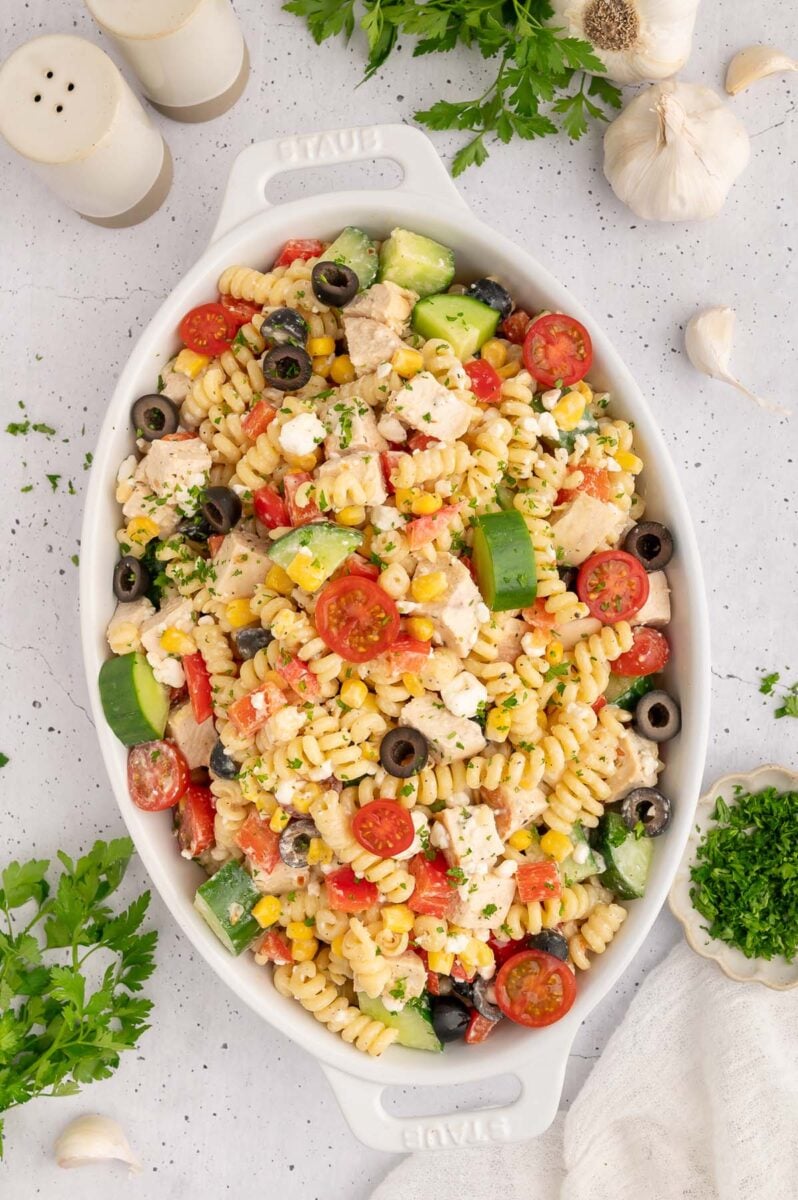 A white dish filled with high protein pasta salad.