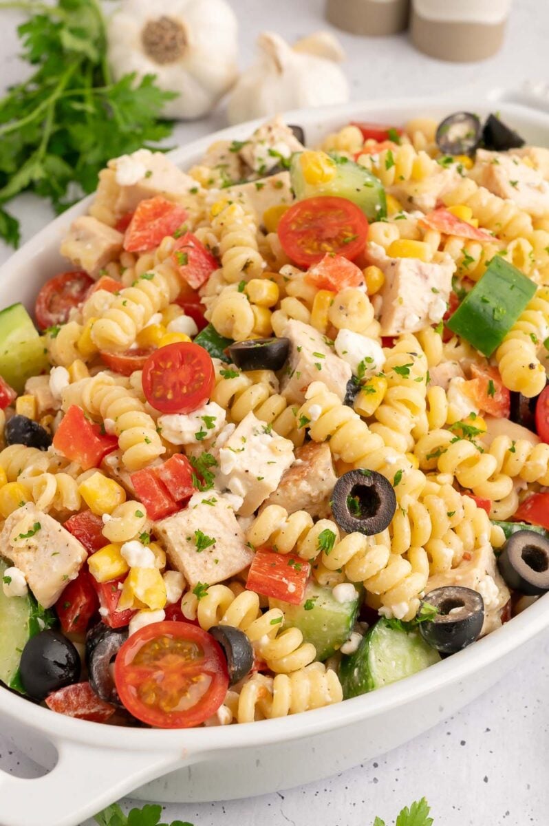 A white dish filled with high protein pasta salad.