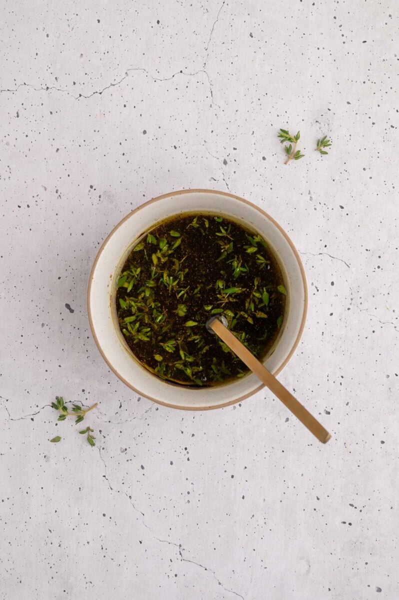 Balsamic chicken marinade in a bowl with a spoon in it. 