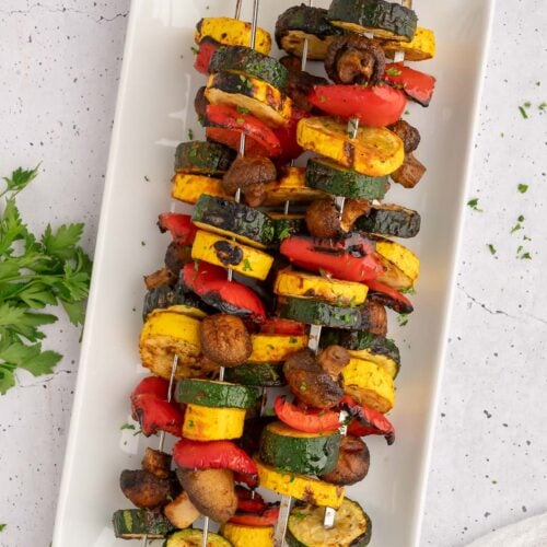 BBQ Grilled Vegetables on kabobs on a white platter.