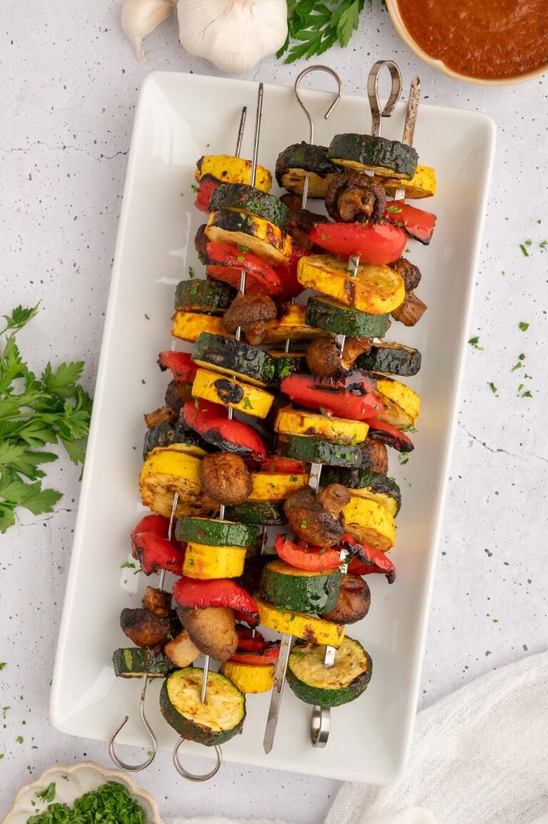BBQ Grilled Vegetables on kabobs on a white platter.