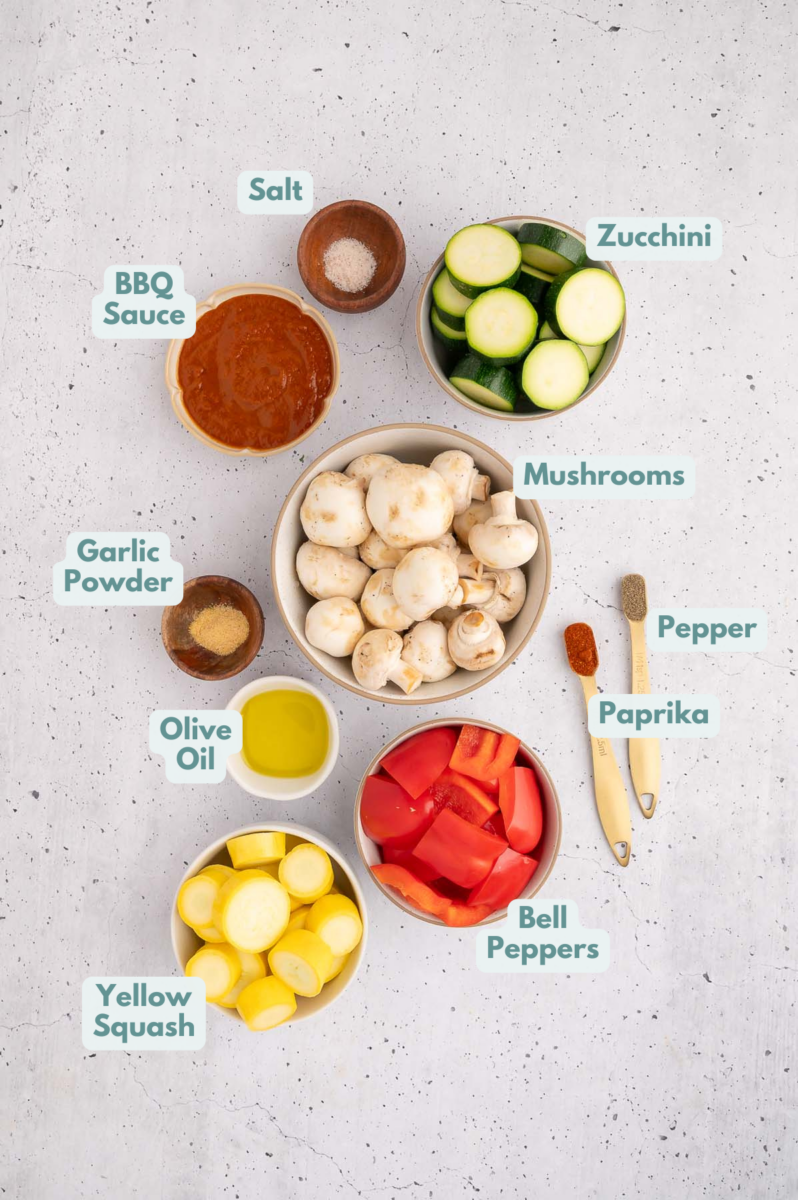 Ingredients to make bbq veggies in bowls and measuring cups on a counter.