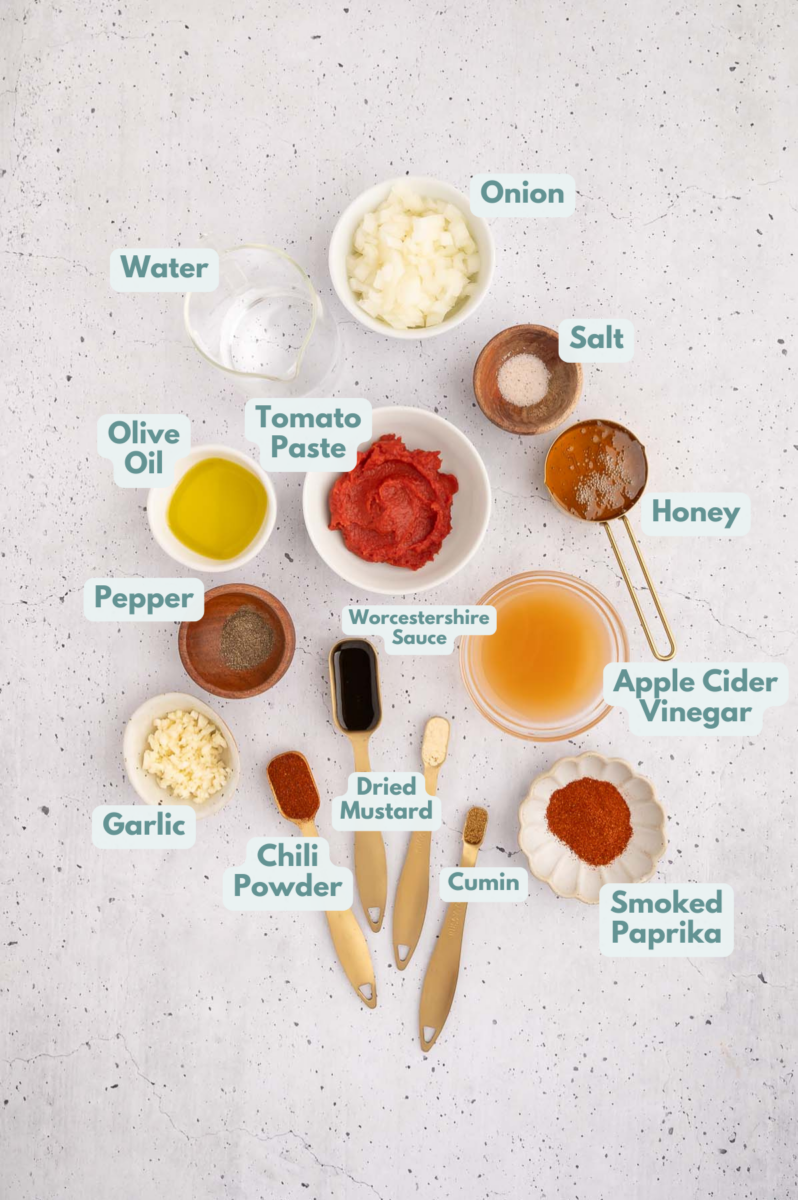 Ingredients to make healthy bbq sauce in bowls and measuring cups on a counter.