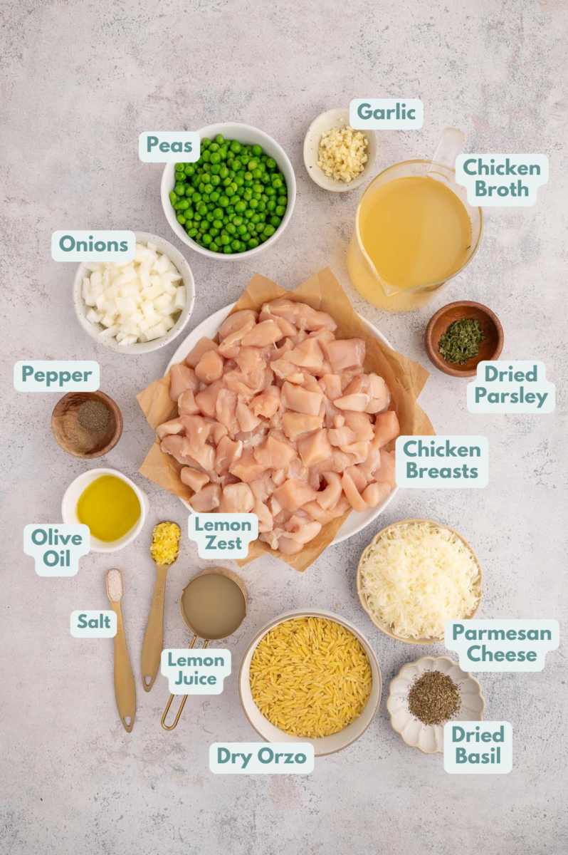 Ingredients to make lemon chicken orzo in bowls and measuring cups on a counter.