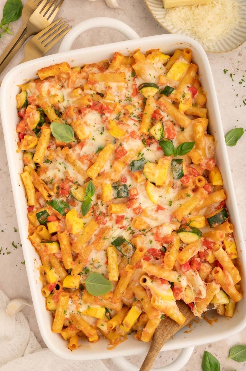 Vegetable Baked Ziti in a white baking dish with a spoon in it.