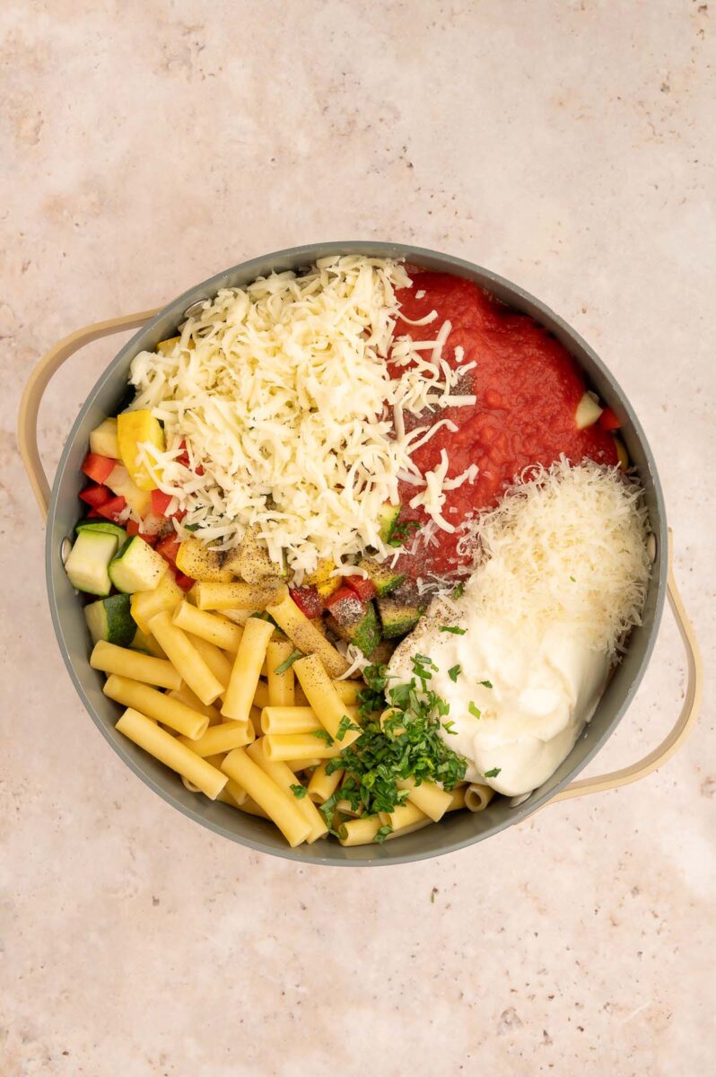 Ingredients for veggie baked ziti in a large pot before stirring together.