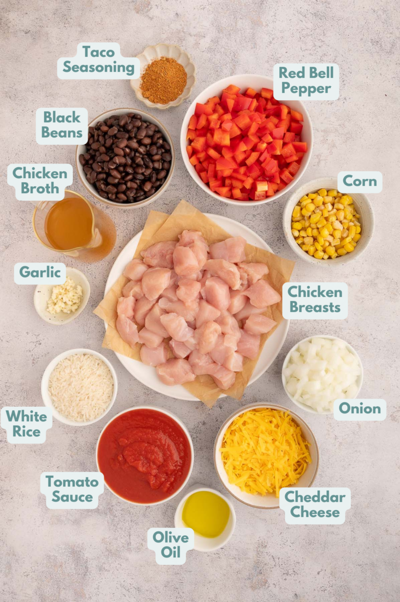 Ingredients to make chicken taco rice in bowls and measuring cups on a counter.