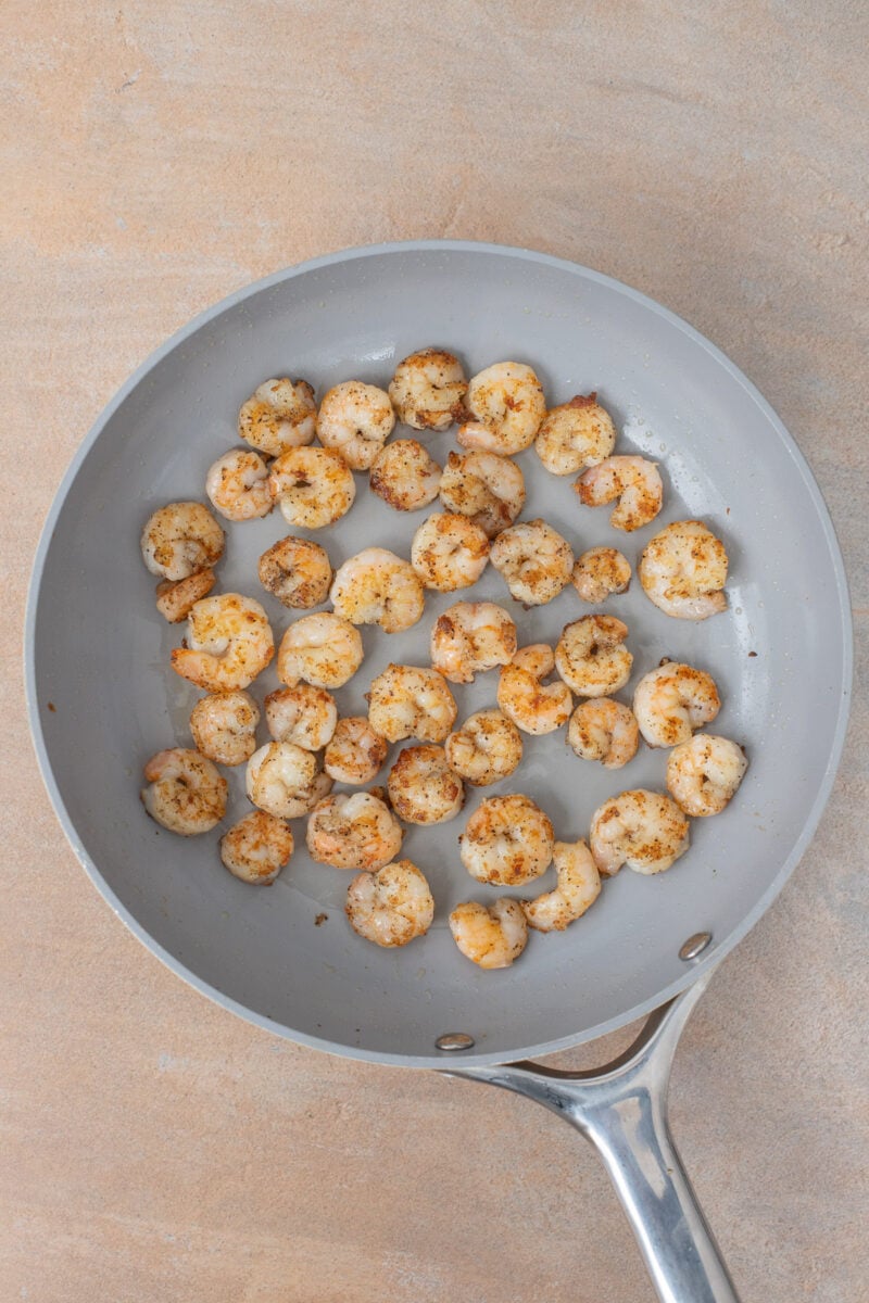 Seasoned shrimp in a pan.