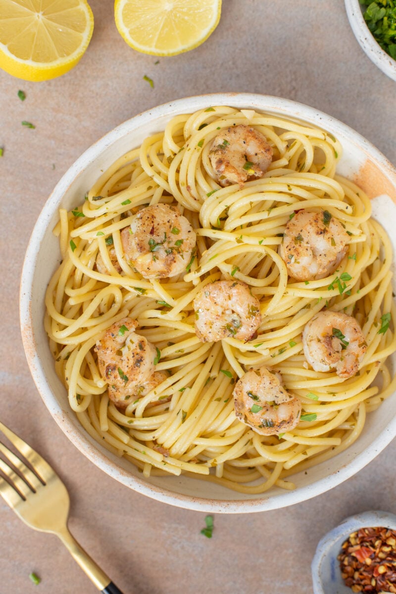 Healthy Shrimp Scampi on a white plate with a gold fork on the side.