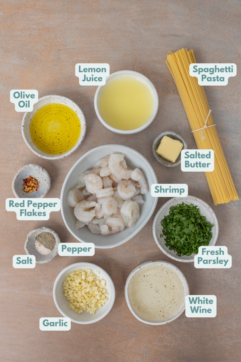 Ingredients to make healthy shrimp scampi in bowls and measuring cups on a counter.