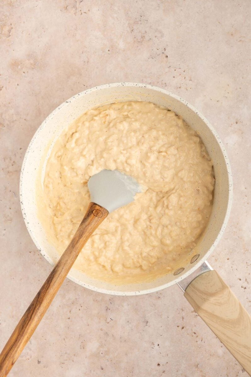 Protein oatmeal in a saute pan with a spatula in it.