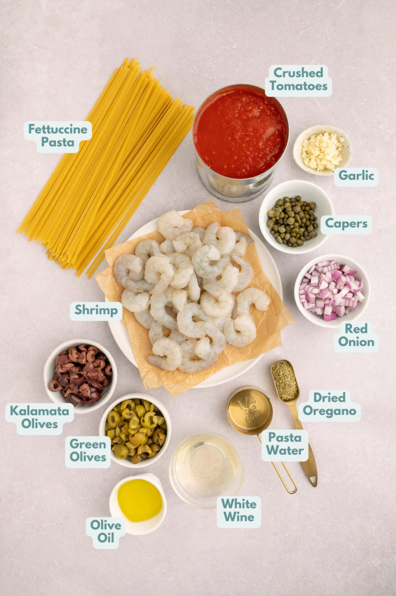 Ingredients for Shrimp Puttanesca in small bowls on a counter with labels.